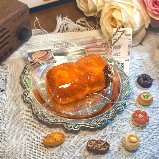 Rich, flaky, and so squishy! 🧈🍫
 The Double Choco Butter Pastry Squishy looks just like a freshly baked layered bun—topped with shiny cocoa glaze and golden edges. Its ultra-realistic folds mimic pastry textures, while the slow-rise bounce makes it perfect for de-stressing.
 An elegant treat for the eyes and the hands