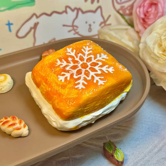 Creamy toast squishy with snowflake frosting and golden finish